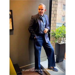 Navy blazer styled with dusty blue silk neckerchief elegantly knotted over striped shirt, showcasing the versatile wear of the paisley silk scarf