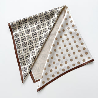 Beige silk bandana scarf with dual pattern design - decorative paisley print on one side and taupe polka dots on the other, bordered with brown trim