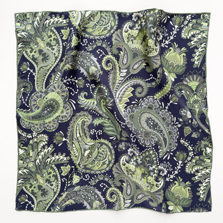 Square silk scarf with intricate paisley pattern in forest green and navy blue, featuring hand-rolled edges and shimmering silk twill texture