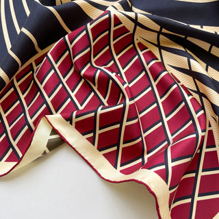 Double-sided Kanagawa Wave silk scarf showing red and black pattern with gold geometric lines, hand-rolled edges and luxurious sheen