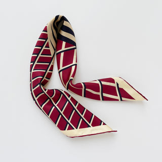 Double-sided silk scarf featuring Kanagawa wave-inspired geometric pattern in red, navy and cream with hand-rolled edges on white background