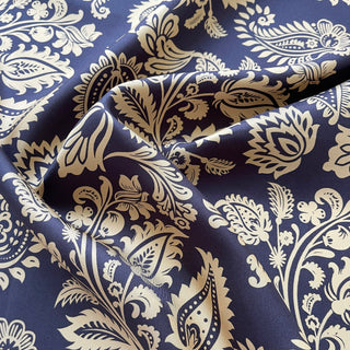 Luxurious navy silk scarf featuring intricate beige paisley pattern with elegant floral motifs, displaying the fabric's smooth texture and lustrous sheen