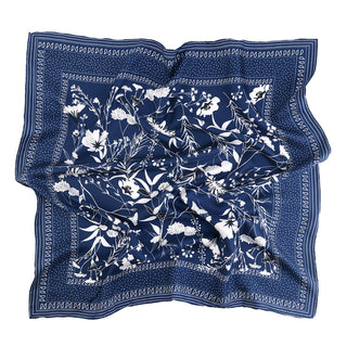 Blue Kyoto Bloom silk scarf with elegant white botanical pattern, featuring hand-rolled edges and dotted border design on luxurious twill fabric.