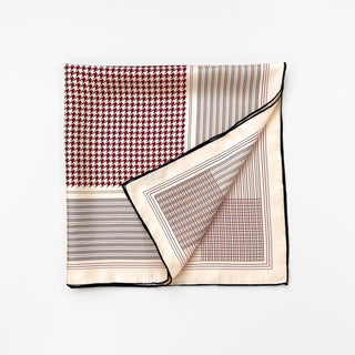 a 70s style printed silk scarf with hand-rolled edges in burgundy and yellowish brown tone