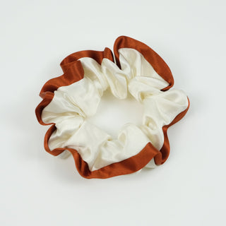 Luxurious silk scrunchie with cream center and copper-brown trim edge, showing the ruffled texture of handmade Monet Touch hair tie
