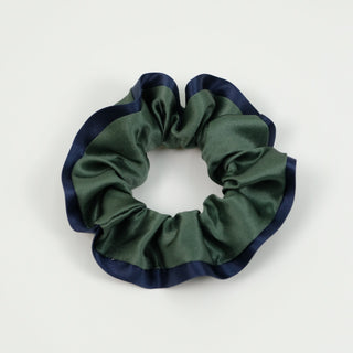 Luxurious silk scrunchie in forest green with navy blue trim, featuring a ruffled design on white background. Part of handmade 3-piece set.