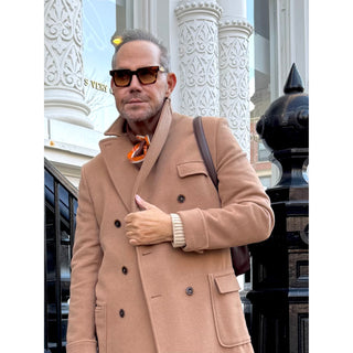Man wearing a brown and orange English plaid cashmere silk blended scarf by LuluLane in beige coat showcasing the timeless sophisticated style.