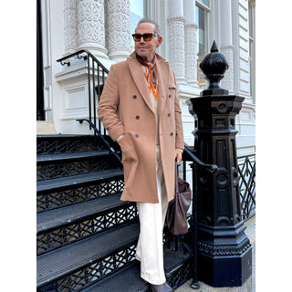 Man wearing a brown and orange English plaid cashmere silk blended scarf by LuluLane in beige coat showcasing the timeless sophisticated style.