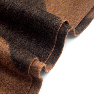 Close-up of brown and black herringbone cashmere scarf showing soft texture.