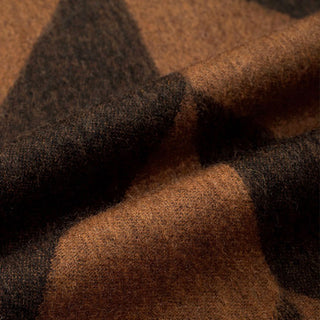 Close-up of brown and black herringbone cashmere scarf showing soft texture.