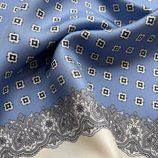 Close-up of cornflower blue silk scarf featuring vintage micro-motifs and lace-inspired border, 65cm square design.