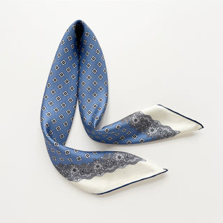 Cornflower blue silk scarf featuring vintage micro-motifs and lace-inspired border, 65cm square design with hand-rolled hems.