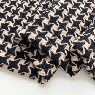 Close-up of a black and beige pure cashmere scarf with houndstooth check pattern