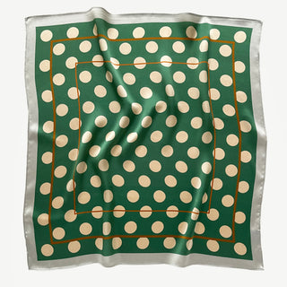 Jade green silk square scarf with cream polka dots displayed flat showing subtle fabric texture.