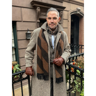 Man wearing a lead grey silk square neckerchief and a brown cashmere scarf by LuluLane showcasing a sharp and refined look.