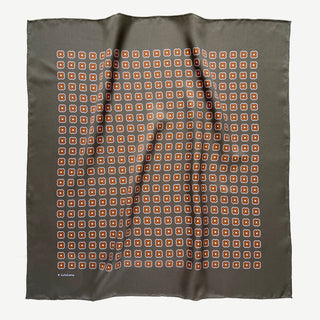 Lead grey silk square scarf by LuluLane with rust red four-petal flower motif, double-sided print and hand-rolled hems.