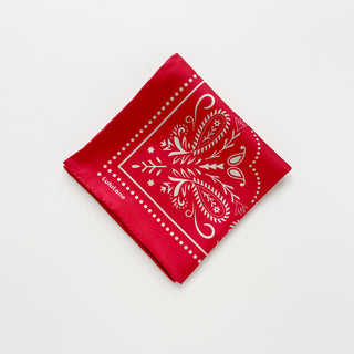 Folded red silk square scarf with double-sided bandana print, 100% silk twill by LuluLane.