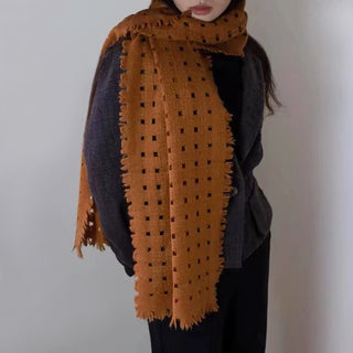 Woman wearing a mustard 100% cashmere scarf by LuluLane with dark grey blouse.