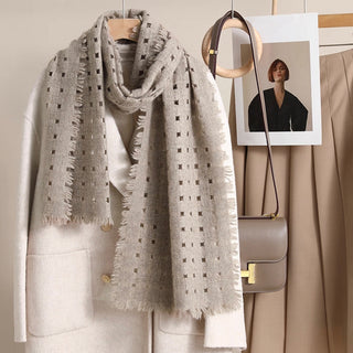 Beige cashmere scarf by LuluLane paired with a cream white coat with beige skirt showcasing the timeless and sophisticated style.