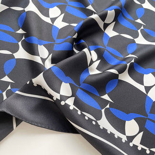 Close-up of women’s silk scarf 90cm in pebble-inspired print, English seaside tones, large square with hand-rolled hems by LuluLane.