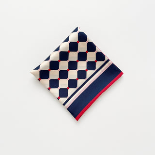Folded unisex silk scarf 65cm chess board design in navy and ivory with red accents, double-sided silk, hand-rolled edges by LuluLane.