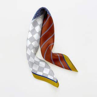 navy silk square neckerchief with geometric patterns featuring blue, rust, gold and white sections with detailed diamond motifs and dotted designs