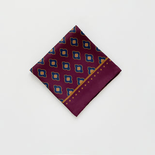 Folded men’s paisley silk scarf 65cm in burgundy, double-sided silk twill square with hand-rolled hems by LuluLane