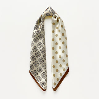 Beige silk scarf by LuluLane with intricate black paisley pattern on one side, solid cream colour on the other, featuring elegant brown border trim