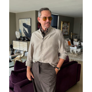 Man wearing a lead grey silk neckerchief with rust red four-petal flower motif showcasing a sharp and refined look.