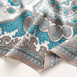 Elegant silk scarf with vintage baroque pattern in turquoise blue and taupe on cream background, featuring ornate medallions and decorative border