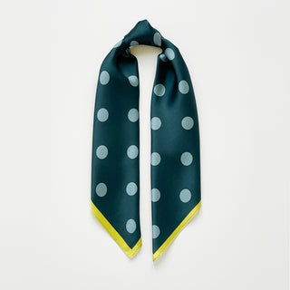 Teal green silk square scarf with light blue polka dots and a mustard yellow border, displayed draped in a triangle shape on white background