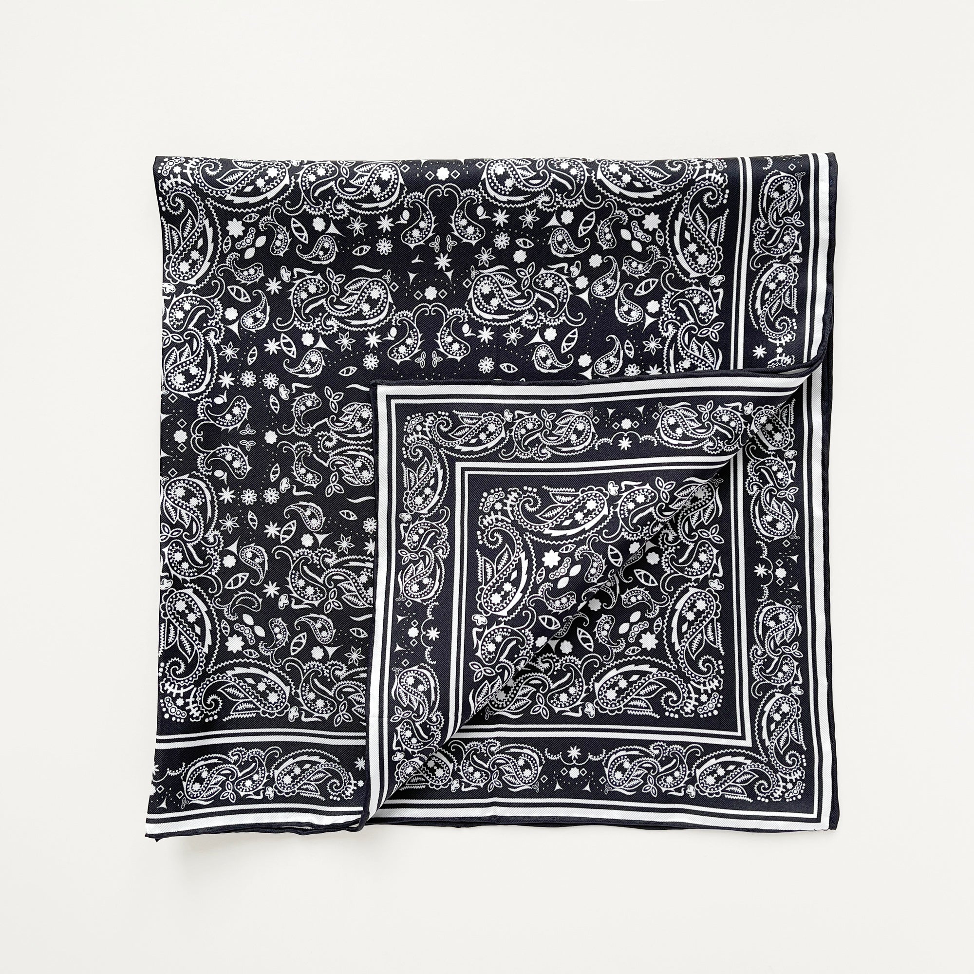 a black and white square silk scarf featuring bohemian paisley print with hand-rolled edges