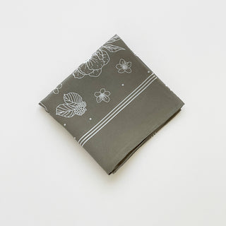Folded women’s silk scarf 58cm in dusty sage green floral print, square silk crepe scarf with hand-rolled edges.
