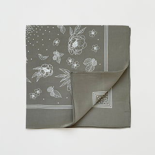 Folded women’s silk scarf 58cm in dusty sage green floral print, square silk crepe scarf with hand-rolled edges.