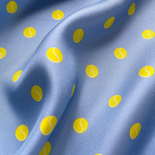 Close-up of women’s sky blue tennis polka dot silk scarf, square bandana inspired by British summer tennis courts