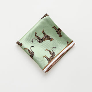 Mint green silk scarf with brown and black leopard print pattern and soft rose gold hand-rolled edges