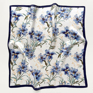 a silk bandana scarf featuring blue bell print with a white base and navy blue edges