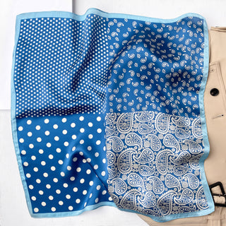 Blue silk bandana scarf with four quadrants of different patterns - polka dots and paisley designs, bordered with light blue trim