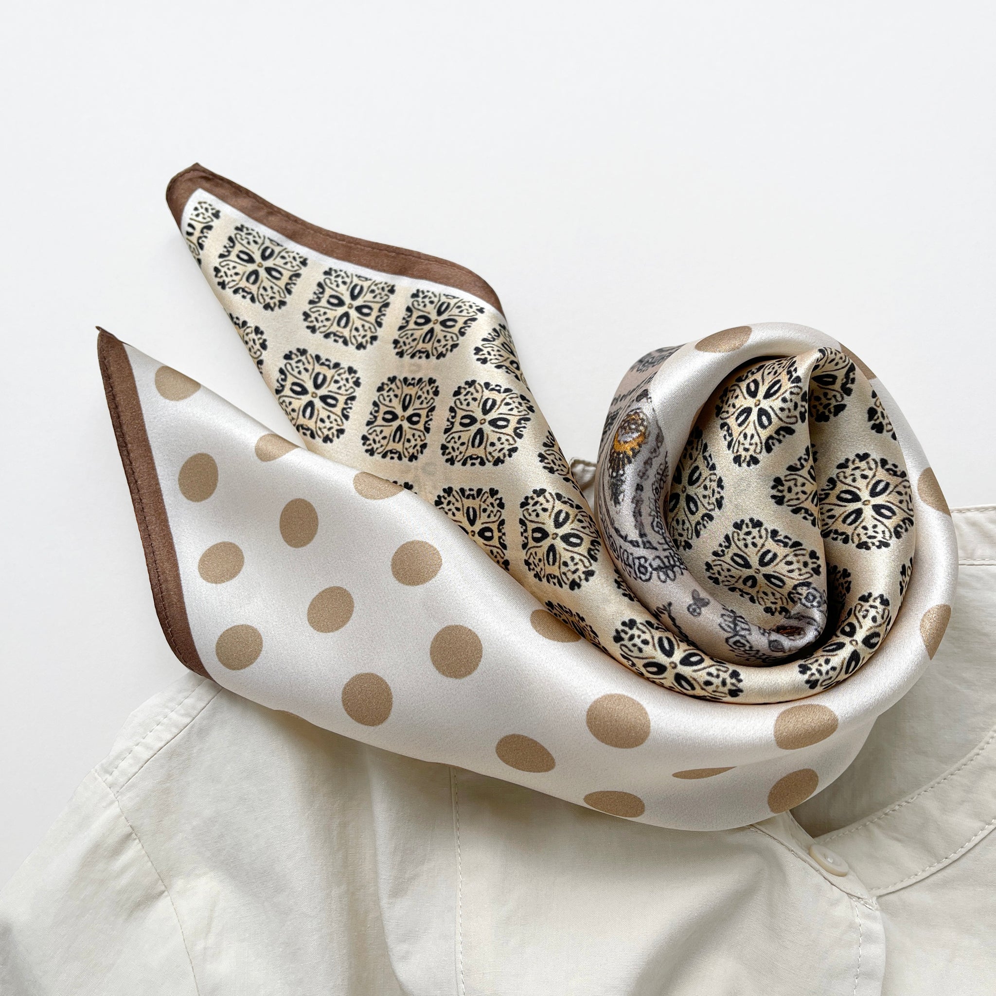 a beige and brown earth tones silk scarf featuring bohemian  paisley and polka dot prints with brown edges
