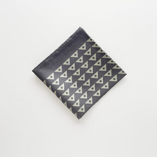 Folded charcoal and pale sage green 65cm men’s silk neckerchief with a modernist triangle print.