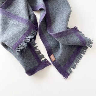 Heather grey cashmere scarf with a purple contrast border, fringed ends and a LuluLane® label.