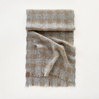 Light grey marl and brown 100% cashmere scarf displayed to show its textured check design and soft drape.