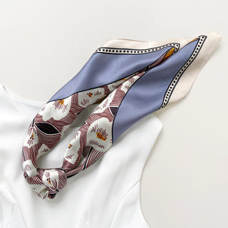 Square silk bandana scarf featuring white rock rose pattern with burgundy details, bordered with lavender blue panels and cream trim with dotted accents
