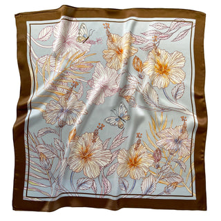Light blue silk scarf with delicate floral pattern featuring cream and orange hibiscus flowers, butterflies, and foliage, framed by a rich brown border