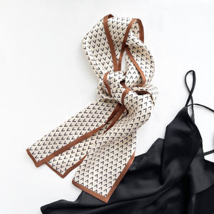a creamy white, taupe and black hue long silk scarf with classic V pattern