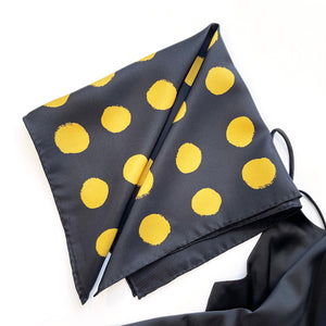 a hand-rolled hems black silk scarf with golden polka dots
