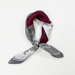 Plum red silk bandana scarf with boho paisley pattern, tied in a classic knot showing gray and white color blocking with decorative edging