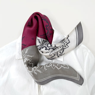 Luxurious plum red silk bandana with boho paisley print, featuring elegant gray and white color blocks and intricate pattern details