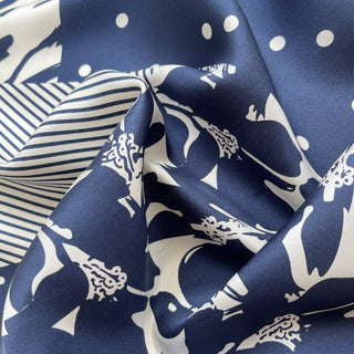 Navy blue and white patterned silk scarf featuring mixed floral, polka dot, and animal print motifs