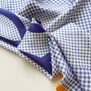 Close-up of checks and houndstooth silk twill scarf in blue and white 